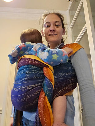 Woman using a woven wrap to carry her baby