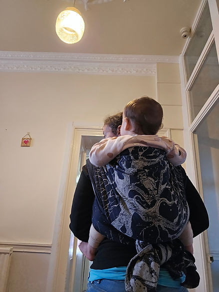 A woman wearing her baby on the back