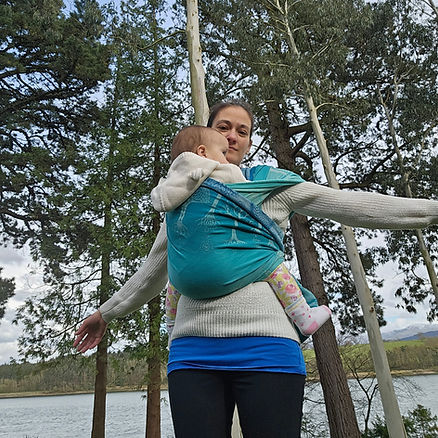 Woman carrying her baby on the front in a woven wrap